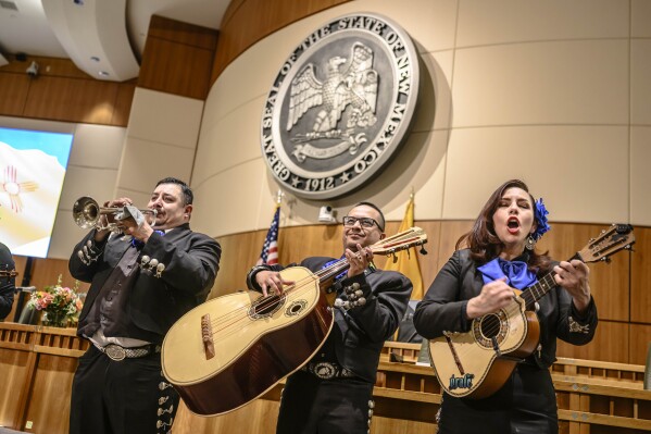The Mariachi group called Euforia entertain lawmakers prior to the start of the 56th Legislature at the Capitol, Tuesday, Jan. 16, 2024, in Santa Fe, N.M. Pictured from left to right are members Lorenzo Lujan, Joseph Varela, and Megan Pacheco. (AP Photo/Roberto E. Rosales)