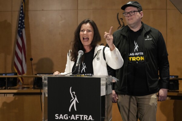 SAG-AFTRA president Fran Drescher, left, and SAG-AFTRA National Executive Director and Chief Negotiator Duncan Crabtree-Ireland speak during a press conference announcing a strike by The Screen Actors Guild-American Federation of Television and Radio Artists on Thursday, July, 13, 2023, in Los Angeles. This marks the first time since 1960 that actors and writers will picket film and television productions at the same time. (AP Photo/Chris Pizzello)