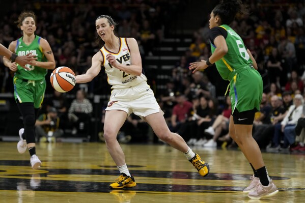 Indiana Fever guard Caitlin Clark, center, passes upcourt during the second half of an exhibition women's basketball game against Brazil, Sunday, May 4, 2025, in Iowa City, Iowa. (AP Photo/Charlie Neibergall)