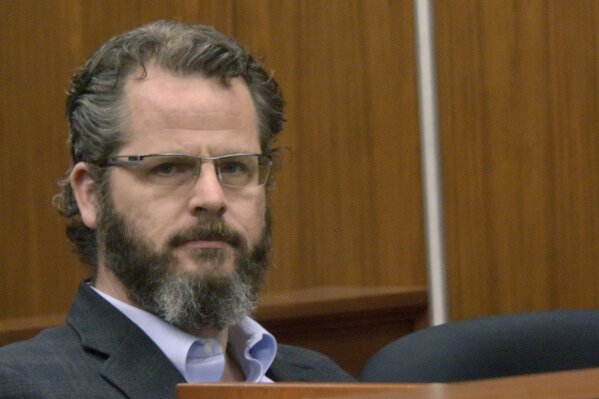 FILE - In this May 25, 2016, file photo former state Rep. Todd Courser attends a probable cause hearing before Judge Hugh Clarke in 65th District Court in Lansing, Mich. Courser has pleaded no contest to a misdemeanor stemming from charges filed over his role in trying to keep his extramarital affair with another legislator from being exposed. The state attorney general's office says Courser entered his plea in a Lapeer County, Mich., courtroom Wednesday, and could serve up to a year in jail on a willful neglect of duty charge. (Dale G. Young /Detroit News via AP, File)