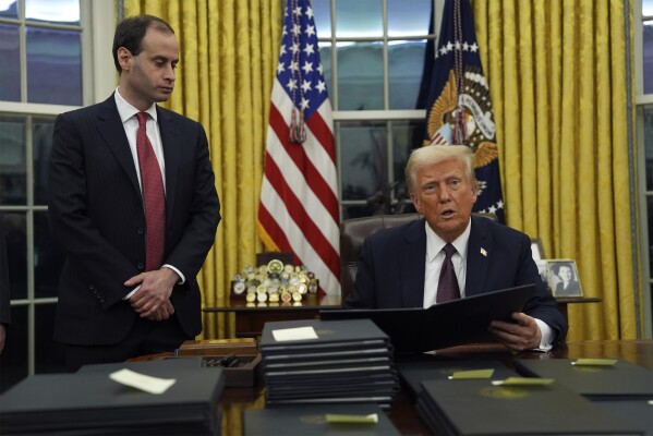 President Donald Trump signs executive orders in the Oval Office of the White House, Monday, Jan. 20, 2025, in Washington. (AP Photo/Evan Vucci)