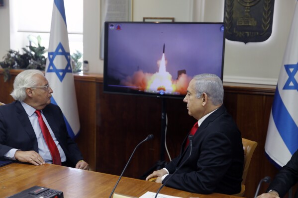 FILE - Israeli Prime Minister Benjamin Netanyahu, right, and US Ambassador to Israel David Friedman watch a video which shows the launch of the Arrow 3 hypersonic anti-ballistic missile during a cabinet meeting in Jerusalem on July 28 2019. The United States cleared a weapons agreement between Israel and Germany that marks Israel’s largest-ever defense deal on Thursday Aug. 17, 2023. (Menahem Kahana/Pool via AP, File)