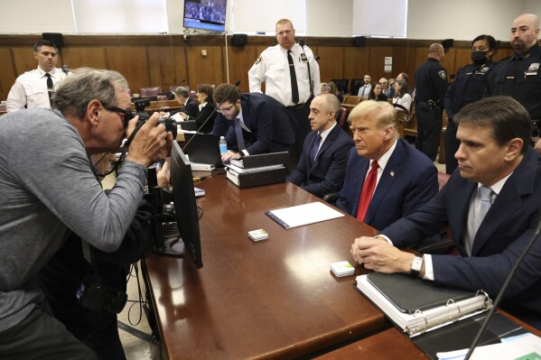 Former President Donald Trump with his lawyers Emil Bove, left, and Todd Blanche, right, appears at Manhattan criminal court before his trial in New York, Thursday, April 25, 2024. (Jefferson Siegel/The New York Times via AP, Pool)