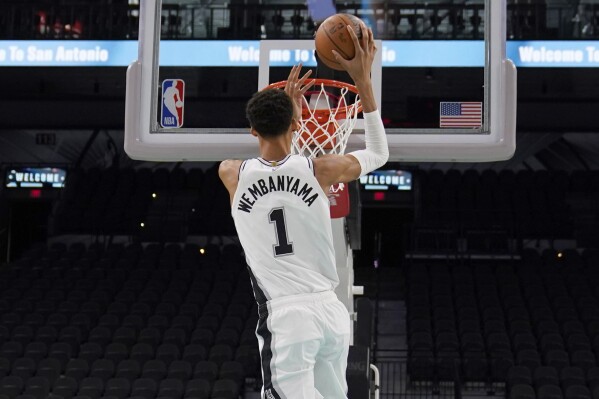 San Antonio Spurs' Victor Wembanyama, the No. 1 draft pick, shoots during an NBA basketball press conference, Saturday, June 24, 2023, at the AT&T Center in San Antonio. (AP Photo/Eric Gay)