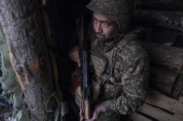 In this photo provided by Ukraine's 93rd Kholodnyi Yar Separate Mechanized Brigade press service, a soldier looks out of a shelter on the anti-drone firing position in Kostyantynivka, the site of the heavy battles with the Russian troops in the Donetsk region, Ukraine, Thursday, April 24, 2025. (Iryna Rybakova/Ukraine's 93rd Mechanized Brigade via AP).