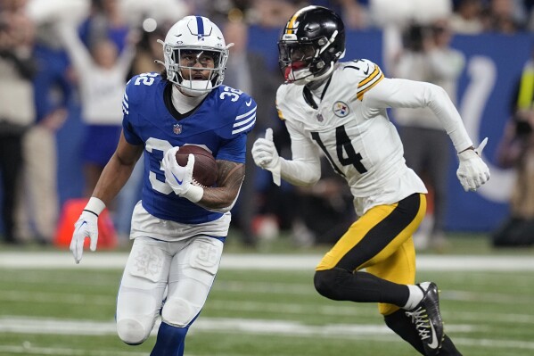 Indianapolis Colts safety Julian Blackmon (32) runs after intercepting a pass intended for Pittsburgh Steelers wide receiver George Pickens (14) during the second half of an NFL football game in Indianapolis Saturday, Dec. 16, 2023. (AP Photo/Darron Cummings)