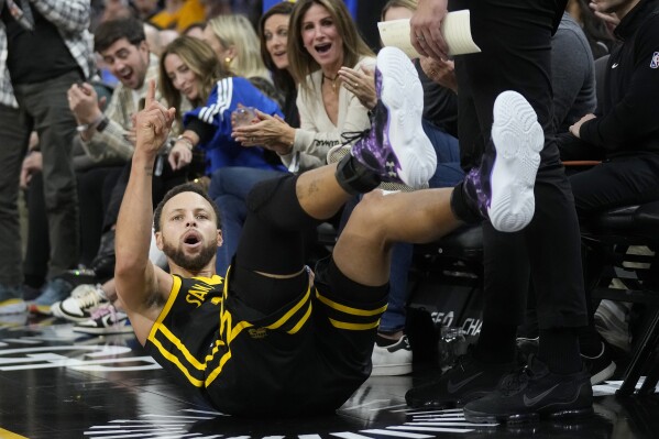 Golden State Warriors guard Stephen Curry reacts after making a 3-point basket and getting fouled during the first half of an NBA basketball game against the Houston Rockets in San Francisco, Monday, Nov. 20, 2023. (AP Photo/Jeff Chiu)