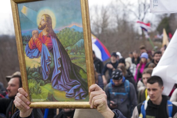Students march trough the fields near the village of Cumic near the Serbian industrial town of Kragujevac, to protest the deaths of 15 people killed in the November collapse of a train station canopy, Friday, Feb. 14, 2025. (AP Photo/Darko Vojinovic)