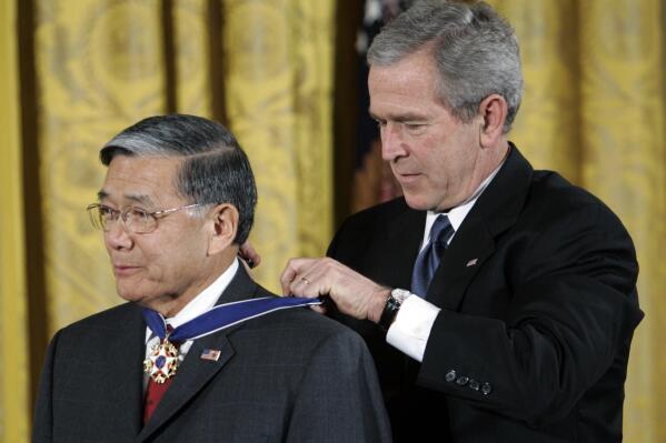 FILE - President Bush, right, bestows the Presidential Medal of Freedom to former Transportation Secretary Norman Y. Mineta during a ceremony in the East Room of the White House in Washington, Friday, Dec. 15, 2006. Mineta, who broke racial barriers for Asian Americans serving in high-profile government posts and ordered commercial flights grounded after the 9/11 terror attacks as the nation's federal transportation secretary, died Tuesday, May 3, 2022. He was 90. (AP Photo/Pablo Martinez Monsivais, File)