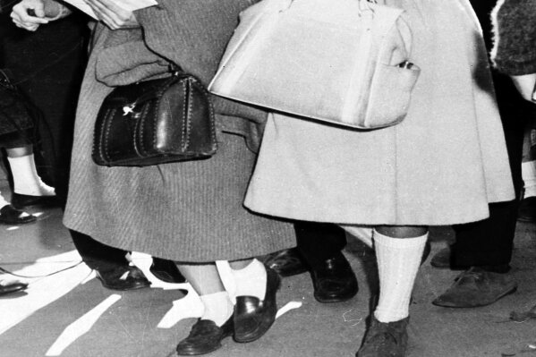 FILE -  In this Jan. 11, 1961 photo, Atlanta Associated Press staffer Kathryn Johnson, left, wears bobby socks and a sweater to obtain the only eyewitness story of Charlayne Hunter's first day of class at the University of Georgia, in Athens, Ga. School officials stopped all other reporters at the door but Johnson, who appeared to look like  "just another student." Hunter was one of the first two African American students to enroll at the University of Georgia. Johnson, a trailblazing reporter for The Associated Press died Wednesday, Oct. 23, 2019, in Atlanta at the age of 93. (AP Photo)