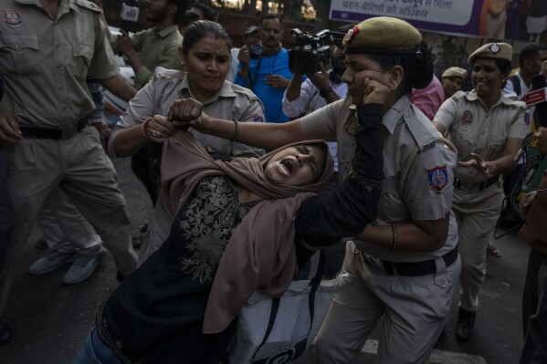 A student activist resists detention while gathering to protest against Israel's military operations in Gaza and to support the Palestinian people, in New Delhi, India, Friday, Oct. 27, 2023. (AP Photo/Altaf Qadri)