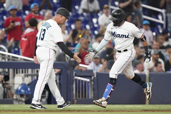 Miami Marlins' Jesus Sanchez, left, is congratulated by first base