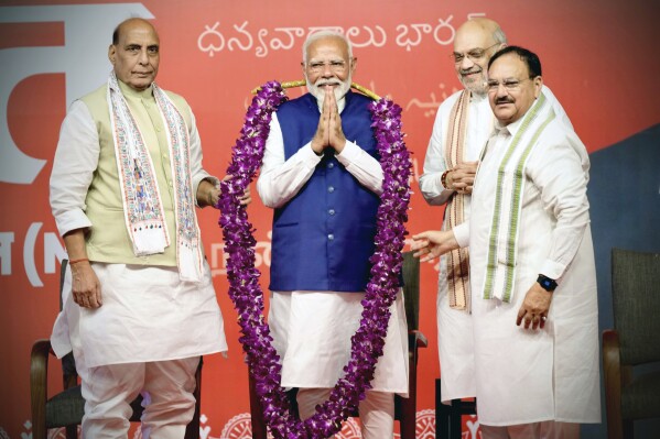 Prime Minister Narendra Modi is garlanded by senior Bharatiya Janata Party (BJP) leaders Rajnath Singh, left, party President JP Nadda, right, and Amit Shah, at the party headquarters in New Delhi, India, Tuesday, June 4, 2024. (AP Photo/Manish Swarup)