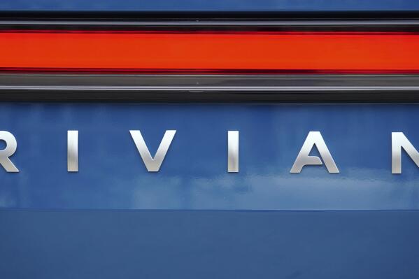 FILE - A Rivian logo is shown on one of the company's electric pickup trucks, Dec. 15, 2021, in Atlanta. Rivian and Mercedes said Thursday, Sept. 8, 2022, that they are teaming up to produce electric vans, starting in a few years. (AP Photo/John Bazemore)