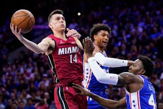 FILE - Miami Heat's Tyler Herro (14) goes up for a shot against Philadelphia 76ers' Matisse Thybulle, center, and Paul Reed during the first half of Game 6 of an NBA basketball second-round playoff series on May 12, 2022, in Philadelphia. Herro and the Miami Heat agreed on a four-year contract extension Sunday, Oct. 2, 2022, that a person with knowledge of the details said could be worth $130 million. (AP Photo/Matt Slocum, File)