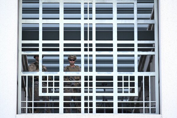 A member of the U.S. military stands guard at the downtown Metropolitan Detention Center Tuesday, June 17, 2025, in Los Angeles. (AP Photo/Wally Skalij)