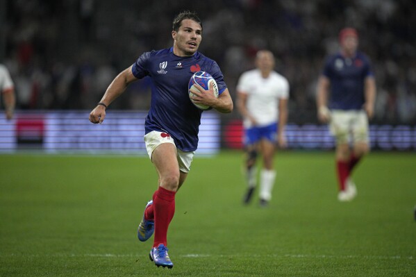 France's Antoine Dupont runs in to score his side's seventh try during the Rugby World Cup Pool A match between France and Namibia at the Stade de Marseille in Marseille, France, Thursday, Sept. 21, 2023. (AP Photo/Daniel Cole)