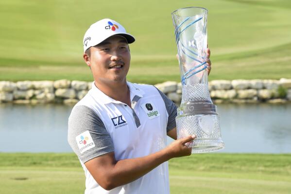 K.H. Lee, of South Korea, holds up the AT&T Byron Nelson golf tournament trophy after winning in McKinney, Texas, on Sunday, May 15, 2022. (AP Photo/Emil Lippe)