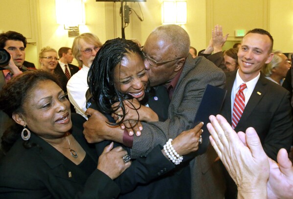Republican Mia Love celebrates with her father, Jean Maxime Bourdeau, after winning the race for Utah's 4th Congressional District during election night in Salt Lake City, Nov. 4, 2014. (AP Photo/Rick Bowmer, File)