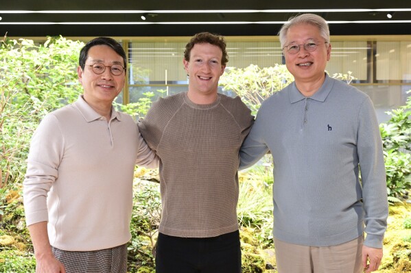 In this photo provided by LG Electronics, its CEO William Cho, from left, Meta CEO Mark Zuckerberg and LG COO Kwon Bong-seok pose for a photo after their meeting at LG Twin Towers headquarters in Seoul, South Korea, Wednesday, Feb. 28, 2024. Zuckerberg discussed cooperation on extended reality (XR) devices with LG Electronics executives on Wednesday, as he visited South Korea for the first time in about 10 years. (LG Electronics via AP)