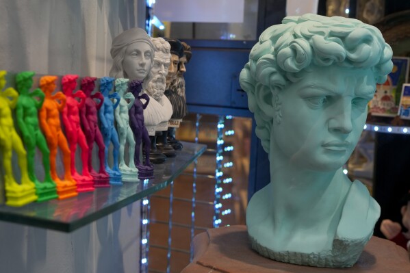 Souvenirs of Michelangelo's 16th century statue of David are seen on sale among other souvenirs in a shop in downtown Florence, central Italy, Monday, March 18, 2024. Michelangelo’s David has been a towering figure in Italian culture since its completion in 1504. But curators worry the marble statue’s religious and political significance is being diminished by the thousands of refrigerator magnets and other souvenirs focusing on David’s genitalia. The Galleria dell’Accademia’s director has positioned herself as David’s defender and takes swift aim at those profiteering from his image. (AP Photo/Andrew Medichini)