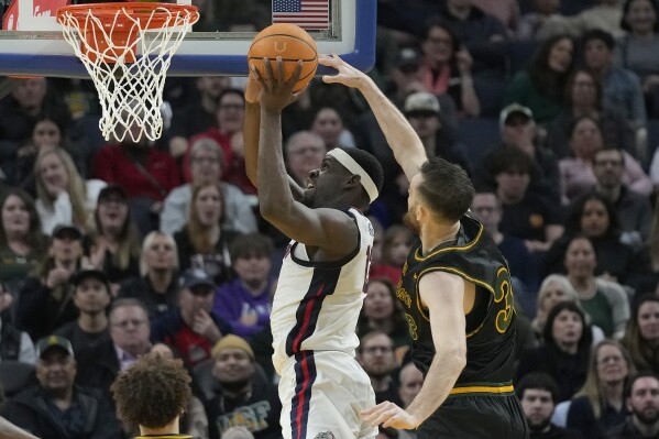 Gonzaga forward Graham Ike, top left, shoots against San Francisco center Volodymyr Markovetskyy during the first half of an NCAA college basketball game in San Francisco, Thursday, Feb. 29, 2024. (AP Photo/Jeff Chiu)