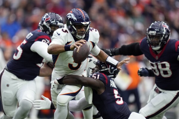 Denver Broncos quarterback Russell Wilson (3) is sacked by Houston Texans defensive end Will Anderson Jr. (51) in the first half of an NFL football game Sunday, Dec. 3, 2023, in Houston. (AP Photo/Eric Christian Smith)