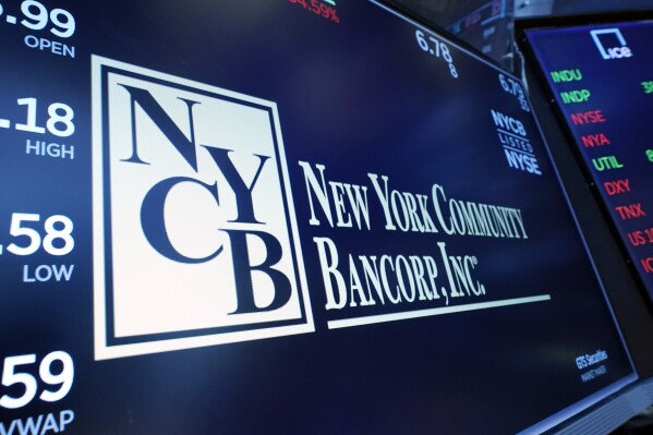FILE - The logo of New York Community Bancorp is shown above a trading post on the floor of the New York Stock Exchange, Jan. 31, 2024. Shares of New York Community Bancorp fell further on Wednesday, March 6, 2024, sending them below $2 and down up more than 80% year to date.  (AP Photo/Richard Drew, File)