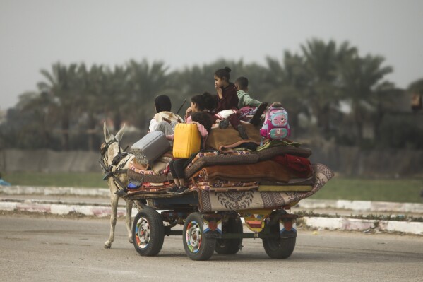 Palestinians flee an Israeli attack in Khan Yunis, Gaza Strip, Wednesday, December 27, 2023.  (AP Photo/Mohammed Dahman)