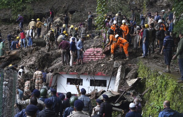 FILE - Rescuers remove mud and debris as they search for people feared trapped after a landslide near a temple on the outskirts of Shimla, Himachal Pradesh state, Aug. 14, 2023. Human-caused climate change is making rain more extreme in the region and scientists warn states should expect more unpredictable and heavy monsoons like this one. (AP Photo/ Pradeep Kumar, File)