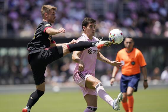 Atlanta United midfielder Amar Sejdic, left, kicks the ball away from Inter Miami forward Robbie Robinson, Sunday, April 24, 2022, during the first half of an MLS soccer match in Fort Lauderdale, Fla. (AP Photo/Wilfredo Lee)