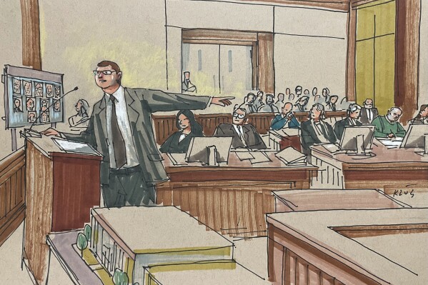 U.S. Attorney Eric Olshan argues before a federal jury that 2018 Pittsburgh synagogue attack defendant Robert Bowers should receive the death penalty, Monday July 31, 2023. Bowers, wearing green, was previously found guilty of killing 11 people in the deadliest antisemitic attack in U.S. history. (Dave Klug via AP)
