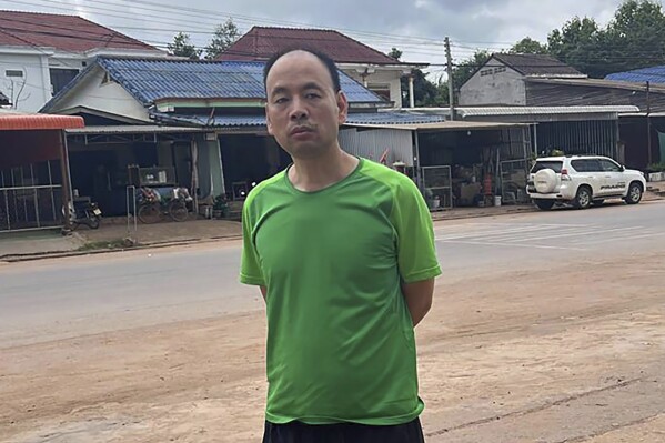 This UGC photo made available by a source wishing to remain anonymous shows Chinese rights lawyer Lu Siwei on a road, at an undisclosed location, around 300 kilometers (186 miles) north of Vientiane, Laos, Thursday, July 27, 2023, as he headed south to the border with Thailand. Lu, stripped of his license for taking on sensitive cases, has been arrested in the Southeast Asian country of Laos, with activists and family members worried he will be deported back to China where he could face prison time.(Anonymous Source via AP)