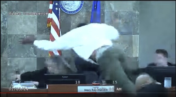 In this image from video provided by the Clark County District Court, a defendant identified by court officials and records as Deobra Redden is seen launching over the desk of Judge Mary Kay Holthus during his sentencing in a felony battery case on Wednesday, Jan. 3, 2024 in Las Vegas. Redden, who was captured in courtroom video leaping over a judge's bench and attacking her, touching off a bloody brawl, is scheduled to appear before her again Monday morning, Jan. 8, 2024. (Clark County District Court via AP)