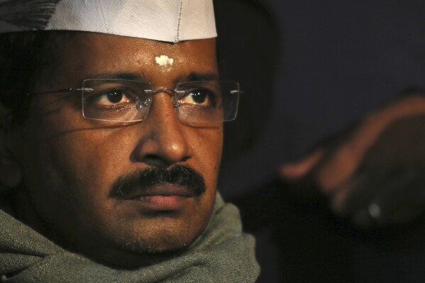 Aam Aadmi Party, or Common Man's Party, leader Arvind Kejriwal listens to a speaker during a public meeting in New Delhi, India, Dec. 27, 2013. The anti-corruption crusader was arrested on Thursday, March 21, 2024, by a federal agency that accused his party and ministers of accepting 1 billion rupees ($12 million) as bribes from liquor contractors nearly two years ago, a top leader of his party said. (AP Photo/Manish Swarup, File)