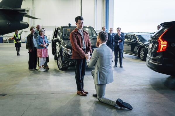 In this photo provided by the Swedish government, Sweden's Johan Floderus, right, kneels as he appears to be proposing to his fiance Johnathan von Fürstenmühl at Arlanda airport in Stockholm, Sweden, Saturday, June 15, 2024, after being released from prison in Iran. Floderus, the Swedish European Union diplomat who was held in Iran for two years and freed in a prisoner swap over the weekend said Tuesday June 18, 2024 that his release was “the dream that I sometimes did not dare to believe in.