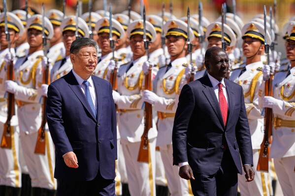 Chinese President Xi Jinping, left, and Kenyan President William Ruto attend a welcome ceremony at the Great Hall of the People Thursday, April 24, 2025 in Beijing, China. (Iori Sagisawa/Pool Photo via AP)
