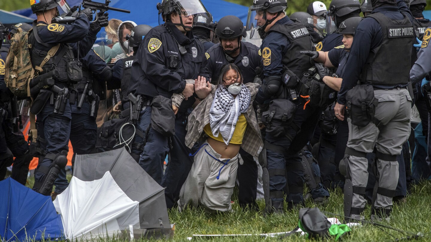 Police lift a pro-Palestinian demonstrator from the ground on the University of Virginia campus, in Charlottesville, Va., where tents are set up, Saturday, May 4, 2024. (Cal Cary/The Daily Progress via AP)