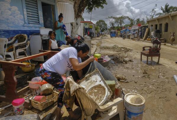 Residents work to recover belongings from flooding caused by Hurricane Fiona in the Los Sotos neighborhood of Higuey, Dominican Republic, Tuesday, Sept. 20, 2022. (AP Photo/Ricardo Hernandez)