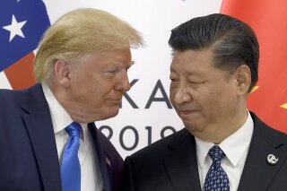 FILE - In this June 29, 2019, file photo, President Donald Trump, left, meets with Chinese President Xi Jinping during a meeting on the sidelines of the G-20 summit in Osaka, Japan. The Democratic impeachment inquiry may give Trump extra motivation to end his trade war with China, claim credit for a policy victory and divert a little attention from a congressional investigation into his dealings with Ukraine. But the partisan wrangling will complicate Trump's ambitious trade agenda overall, including his push to win congressional approval for a revamped North American trade agreement. (AP Photo/Susan Walsh, File)