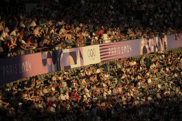 The crowd waits for the 2024 Summer Olympics closing ceremony at the Stade de France, Sunday, Aug. 11, 2024, in Saint-Denis, France. (AP Photo/Dita Alangkara)
