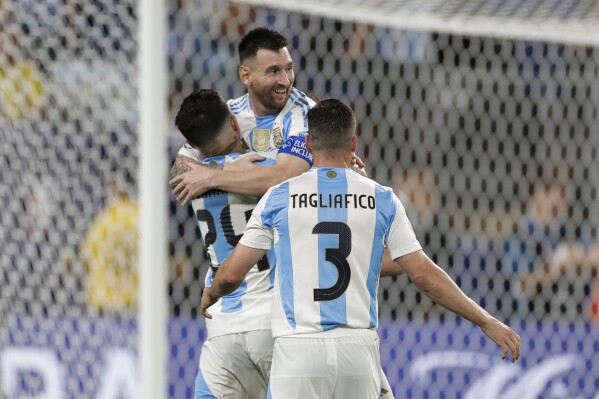 Argentina's Lionel Messi is congratulated after scoring his side's second goal against Canada during a Copa America semifinal soccer match in East Rutherford, N.J., Tuesday, July 9, 2024. (AP Photo/Adam Hunger)