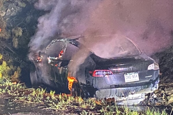 This photo provided by Colorado State Patrol shows a Tesla Model 3 that crashed on May 16, 2022 in Clear Creek County, Colo. (Colorado State Patrol via AP, File)