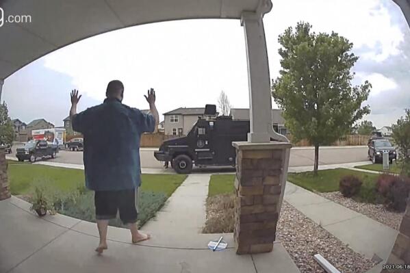 In this image from video provided by Leslie Bowman, Anderson Lee Aldrich surrenders to police at a home where his mother, Laura Voepel, was renting a room in Colorado Springs, Colo., on June 18, 2021. According to sealed law enforcement documents verified by The Associated Press, Aldrich's actions brought SWAT teams and the bomb squad to the normally quiet neighborhood, forced the grandparents to flee for their lives and prompted the evacuation of 10 nearby homes to escape a possible bomb blast. (Leslie Bowman via AP)