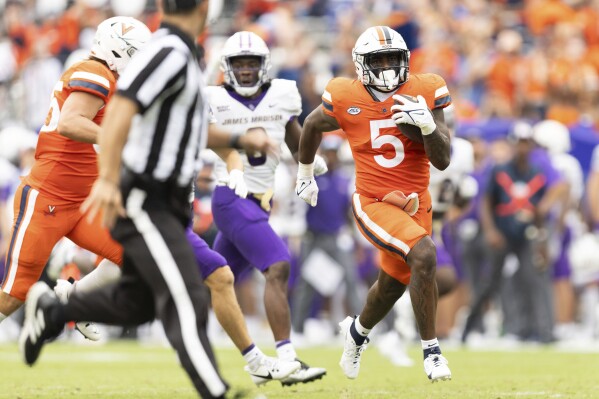 Virginia's Kobe Pace (5) drives with the ball during an NCAA college football game against James Madison in Charlottesville, Va., on Saturday, Sept. 9, 2023. (AP Photo/Mike Kropf)