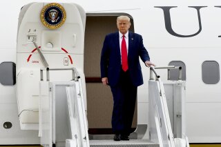 President Donald Trump walks from Air Force One as he arrives at Waukegan National Airport before attending a series of events in Kenosha, WI, Tuesday, Sept. 1, 2020, in Waukegan, IL. (AP Photo/Matt Marton)