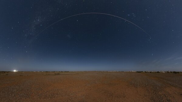 This photo provided by Japan Aerospace Exploration Agency (JAXA) shows the Japanese space capsule about to re-enter Earth with asteroid samples seen in Coober Pedy, southern Australia, on Sunday, D...