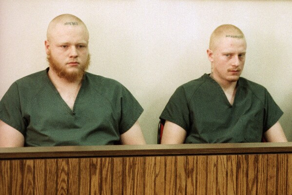 FILE - David Freeman, left, and Bryan Freeman, right, sit with Nelson Birdwell III, not pictured, as they appear in a Midland, Mich., courtroom, March 2, 1995. On Wednesday, Feb. 21, 2024, the two eastern Pennsylvania brothers sentenced to life in the slayings of their parents and younger brother almost three decades ago were resentenced to terms that may offer them a chance at parole. (APPhoto/Dale Atkins, File)