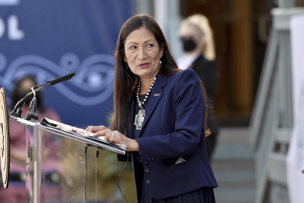 FILE - Interior Secretary Deb Haaland speaks at the Cherokee Immersion School Friday, Dec. 3, 2021, in Tahlequah, Okla. Federal officials have come up with a list of potential replacement names for hundreds of geographic features in three dozen states that include the word "squaw." Haaland in November formally declared the term derogatory and initiated a process to remove the term from use by the federal government and to replace other existing derogatory place names. The list was announced Tuesday, Feb. 22, 2022. (AP Photo/Michael Woods,File)
