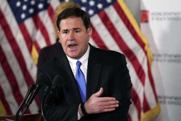 FILE - Arizona Gov. Doug Ducey answers a question during a news conference in Phoenix, on Dec. 2, 2020. The outgoing Republican governor said Wednesday, Nov. 23, 2022, that his Republican administration will ensure an orderly transition to Democrat Katie Hobbs, his first public statement on her victory. (AP Photo/Ross D. Franklin, Pool, File)